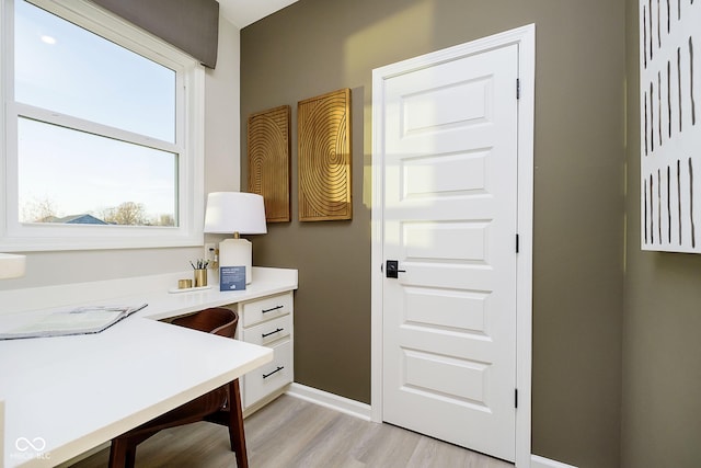 office area with light wood-style flooring and baseboards