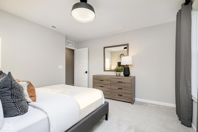 bedroom with light carpet and baseboards