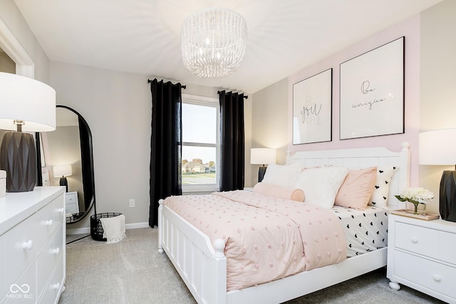 bedroom with light colored carpet, a chandelier, and baseboards