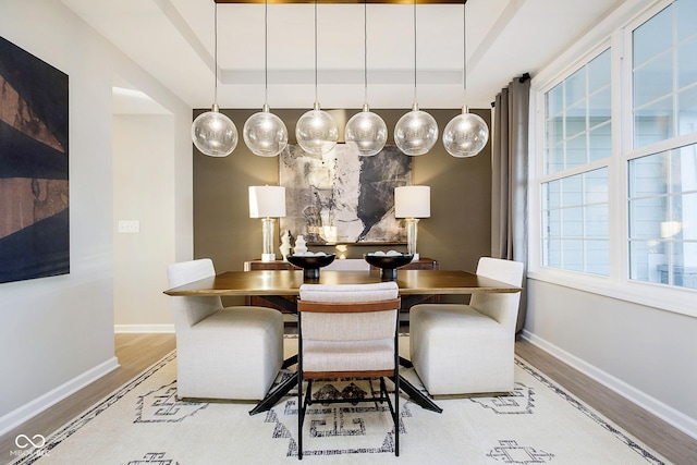 dining space with wood finished floors and baseboards