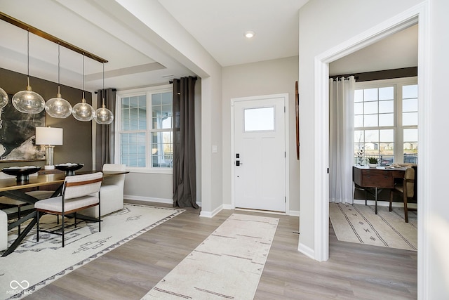 entrance foyer featuring wood finished floors and baseboards