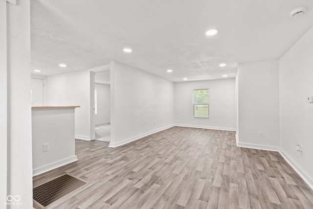 2321 W 26th St, Anderson, IN 46016 - empty room with light wood-style floors, recessed lighting, baseboards, and a smoke detector