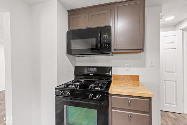 2321 W 26th St, Anderson, IN 46016 - kitchen featuring black appliances and light wood-style floors