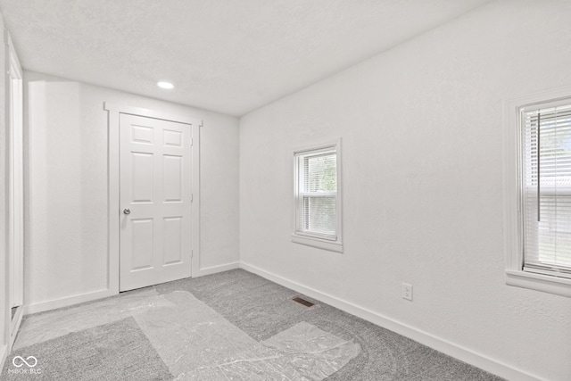 2321 W 26th St, Anderson, IN 46016 - unfurnished room with baseboards, plenty of natural light, and carpet floors