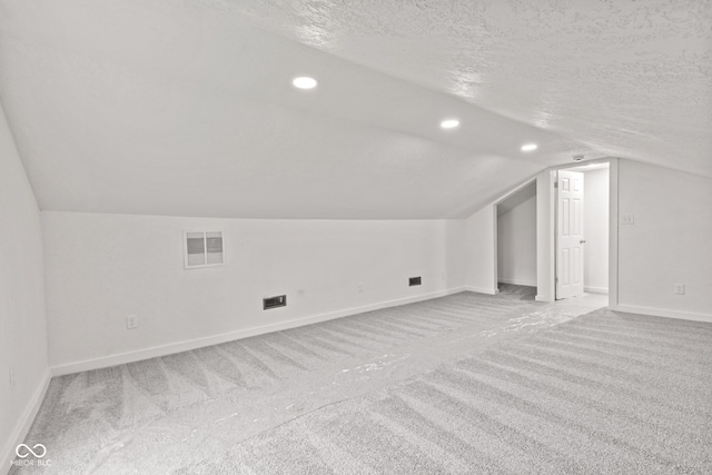 2321 W 26th St, Anderson, IN 46016 - bonus room featuring carpet floors, vaulted ceiling, baseboards, a textured ceiling, and recessed lighting