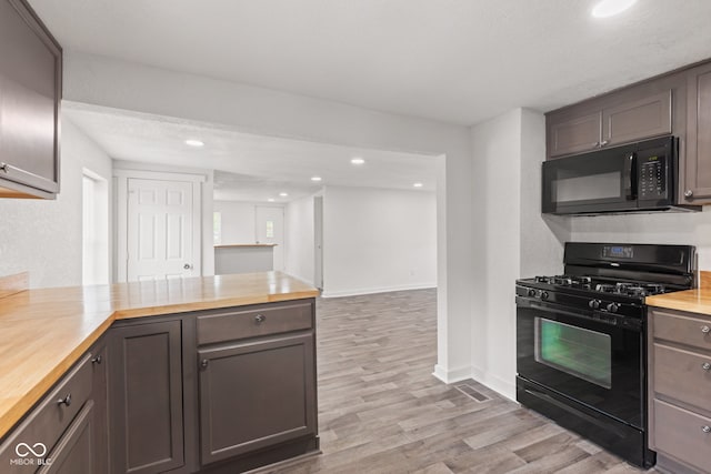 2321 W 26th St, Anderson, IN 46016 - kitchen featuring black appliances, wood counters, light wood-style flooring, and recessed lighting