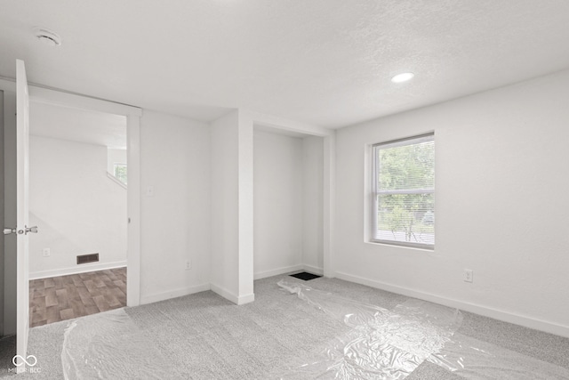 2321 W 26th St, Anderson, IN 46016 - empty room with carpet flooring, baseboards, a textured ceiling, and a smoke detector