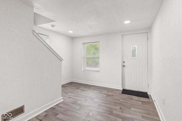 2321 W 26th St, Anderson, IN 46016 - entrance foyer featuring wood finished floors, baseboards, a textured ceiling, and recessed lighting