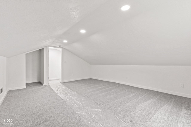 2321 W 26th St, Anderson, IN 46016 - additional living space featuring carpet, lofted ceiling, recessed lighting, baseboards, and a textured ceiling
