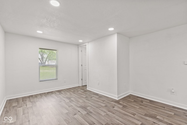 2321 W 26th St, Anderson, IN 46016 - spare room with recessed lighting, wood finished floors, and baseboards