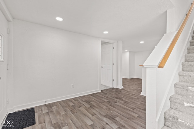 2321 W 26th St, Anderson, IN 46016 - below grade area with wood finished floors, stairs, baseboards, and recessed lighting