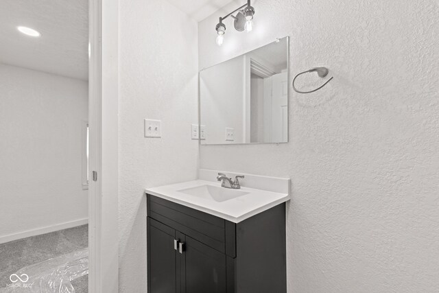 2321 W 26th St, Anderson, IN 46016 - bathroom featuring a textured wall and vanity