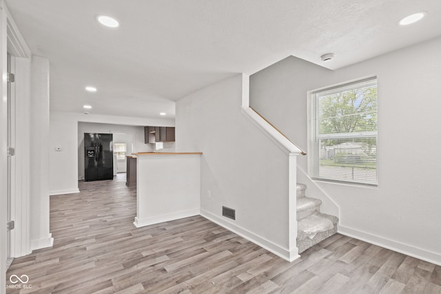 2321 W 26th St, Anderson, IN 46016 - staircase featuring wood finished floors, baseboards, and recessed lighting