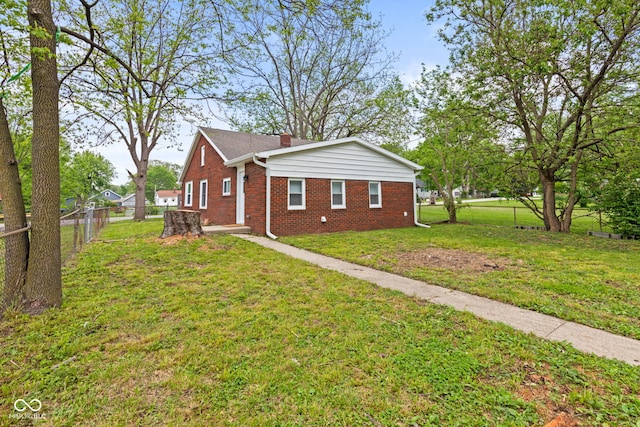 2321 W 26th St, Anderson, IN 46016 - view of property exterior featuring brick siding and a chimney