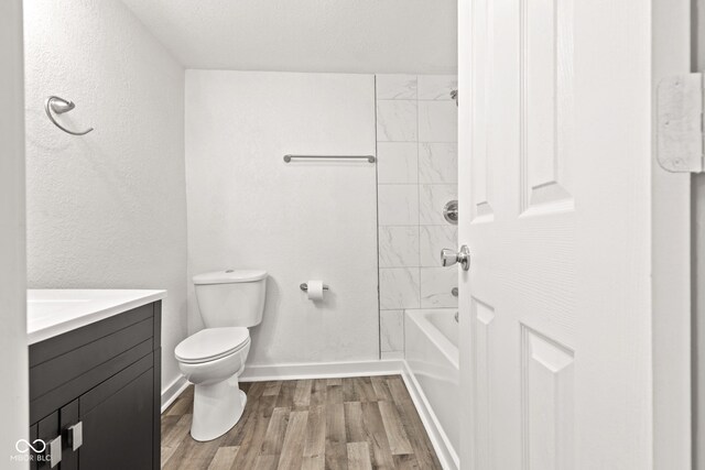 2321 W 26th St, Anderson, IN 46016 - full bath with wood finished floors, toilet, vanity, baseboards, and bathtub / shower combination