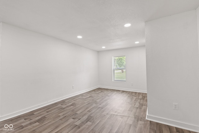 2321 W 26th St, Anderson, IN 46016 - spare room featuring recessed lighting, wood finished floors, and baseboards