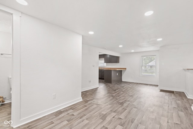 2321 W 26th St, Anderson, IN 46016 - unfurnished living room featuring light wood finished floors, recessed lighting, and baseboards