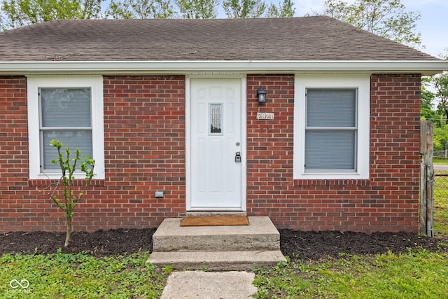 2321 W 26th St, Anderson, IN 46016 - entrance to property with fence, roof with shingles, and brick siding
