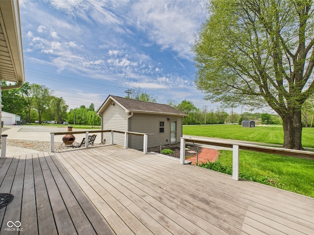 wooden terrace with a yard and an outbuilding