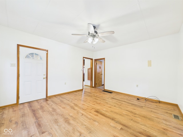 unfurnished room with light wood finished floors, baseboards, and ceiling fan