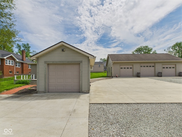 view of front of property with an outdoor structure and concrete driveway