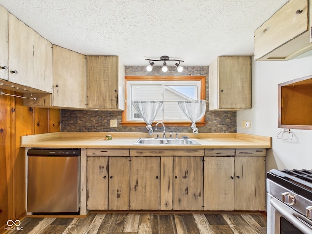 kitchen with stainless steel appliances, a sink, tasteful backsplash, light countertops, and a textured ceiling