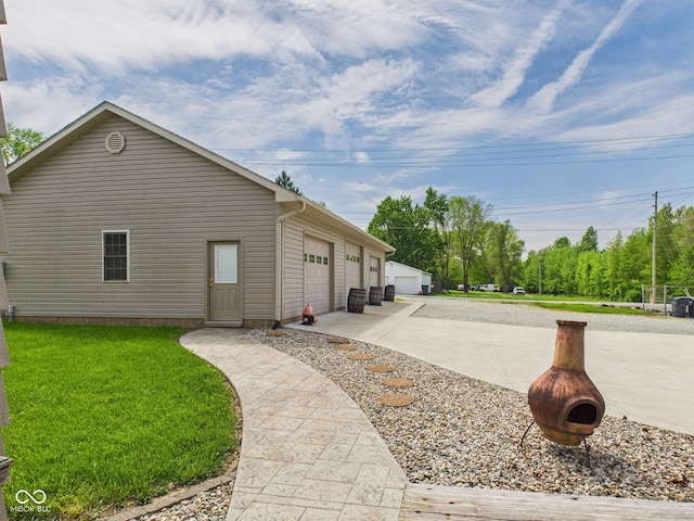 view of side of property featuring a yard and a garage