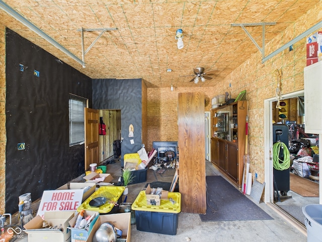 misc room with a ceiling fan and concrete flooring