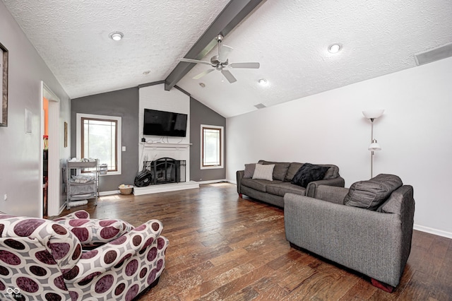 living room featuring a textured ceiling, hardwood / wood-style flooring, ceiling fan, plenty of natural light, and baseboards