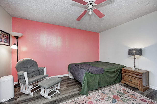 bedroom featuring wood finished floors, a textured ceiling, baseboards, and ceiling fan