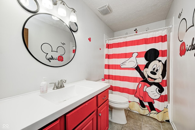 bathroom with toilet, vanity, a textured ceiling, and a shower with shower curtain