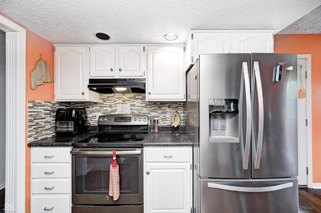 kitchen featuring appliances with stainless steel finishes, under cabinet range hood, dark countertops, a textured ceiling, and white cabinets