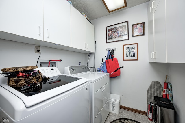 laundry room featuring cabinet space, independent washer and dryer, baseboards, and light tile patterned floors