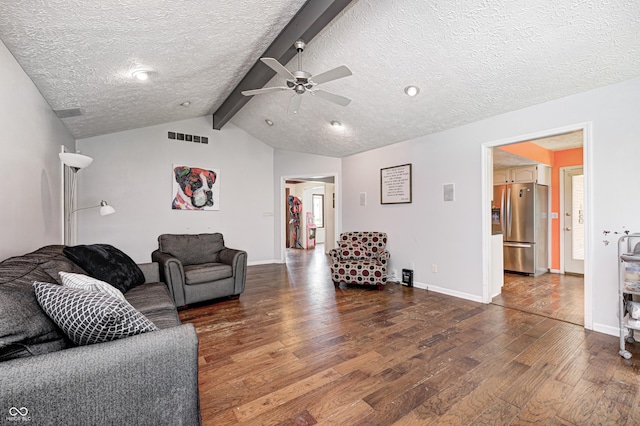 living area featuring hardwood / wood-style flooring, a textured ceiling, ceiling fan, and baseboards
