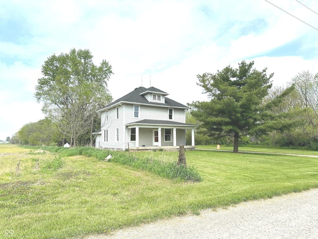 view of front of house with a porch and a front yard