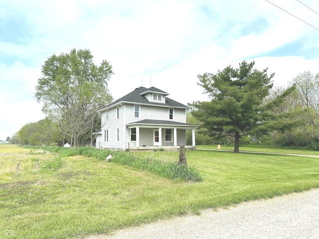 view of front of house with a porch and a front yard