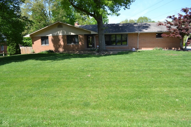 view of front facade featuring brick siding and a shingled roof