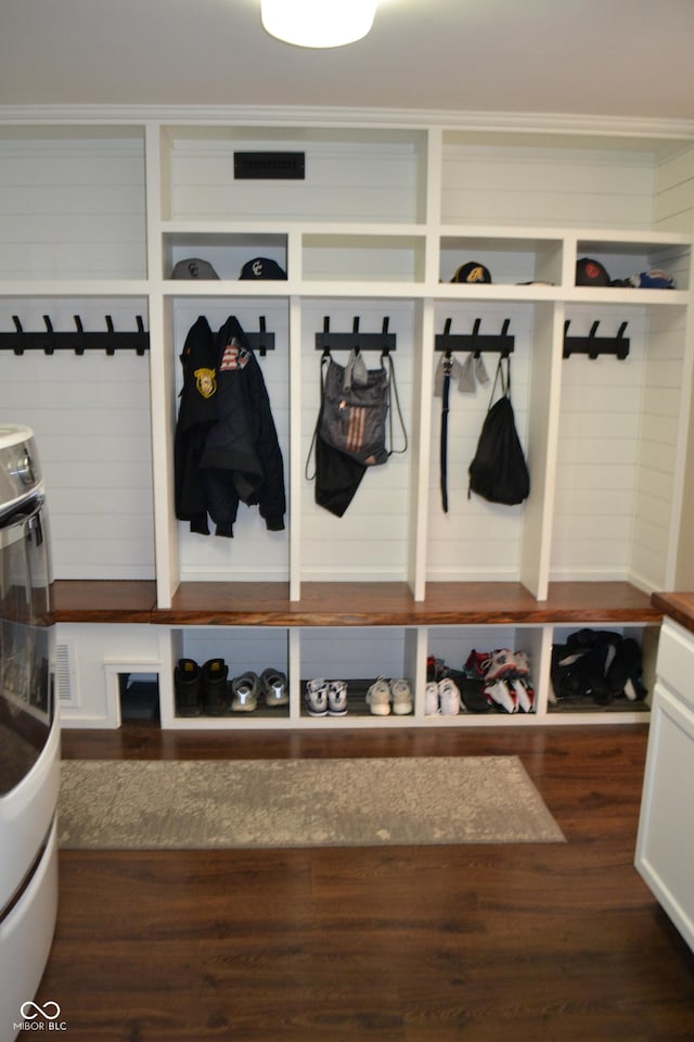 mudroom with crown molding and dark wood finished floors