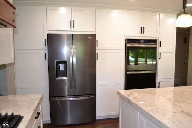 kitchen with stainless steel appliances, white cabinetry, light stone countertops, pendant lighting, and dark wood-style flooring