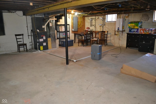 below grade area featuring heating unit, water heater, and electric panel