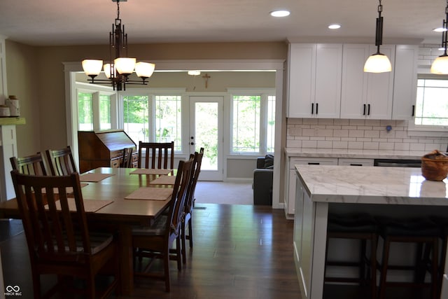 dining room with a chandelier, dark wood-type flooring, recessed lighting, and baseboards