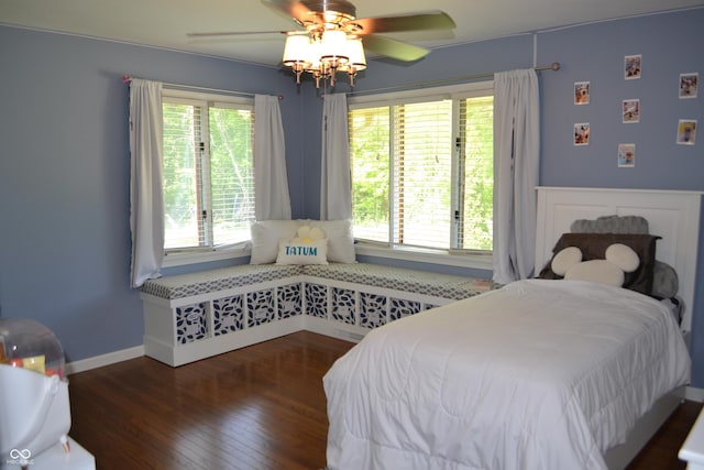 bedroom featuring wood-type flooring, a ceiling fan, and baseboards