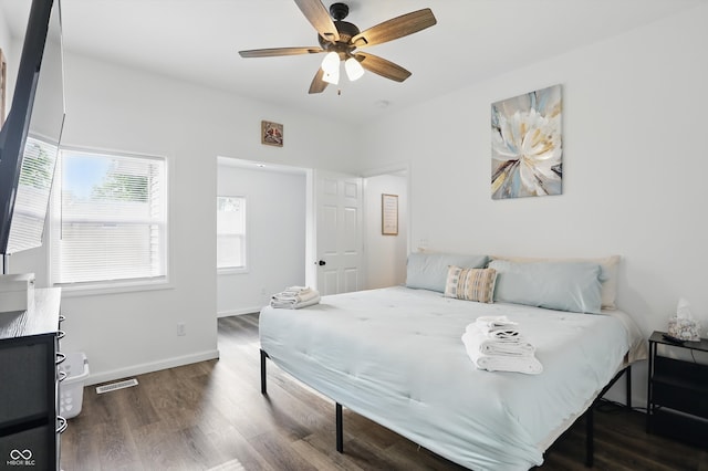 bedroom featuring wood finished floors, baseboards, and a ceiling fan