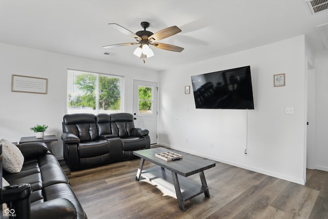 living room featuring a ceiling fan, wood finished floors, and baseboards
