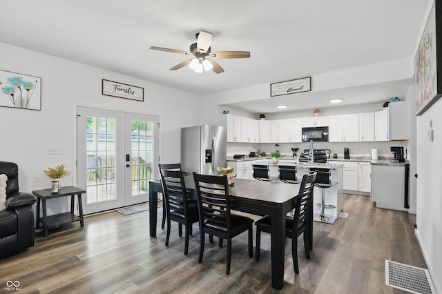 dining room featuring a ceiling fan, french doors, and wood finished floors