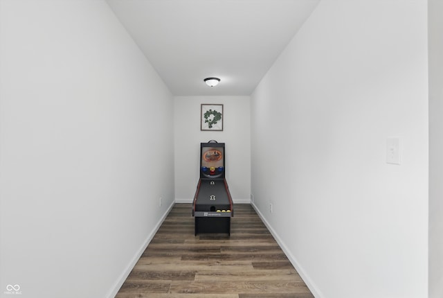hallway with wood finished floors and baseboards