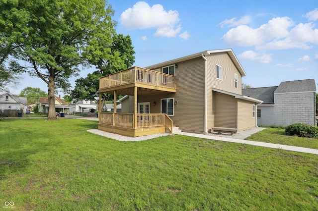 rear view of house featuring a yard and a wooden deck