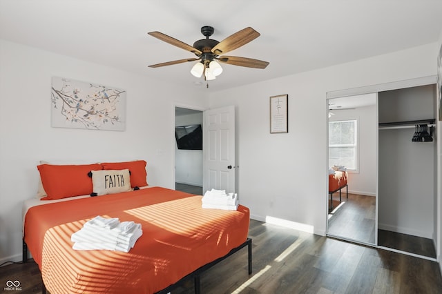 bedroom with wood finished floors, a closet, baseboards, and ceiling fan