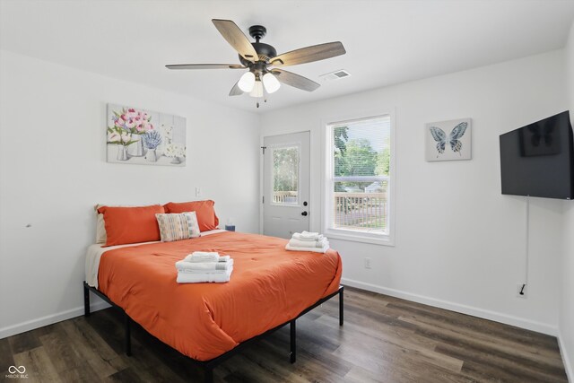 bedroom with wood finished floors, baseboards, and a ceiling fan