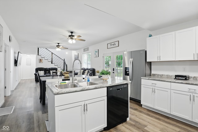 kitchen with dishwasher, a sink, white cabinetry, an island with sink, and open floor plan